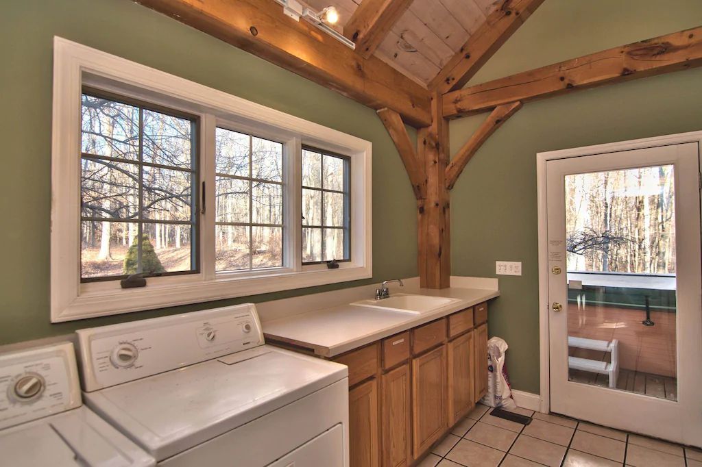 A laundry room with a washer and dryer and a sink