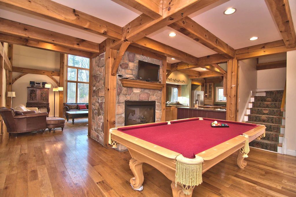 There is a pool table in the middle of the room.