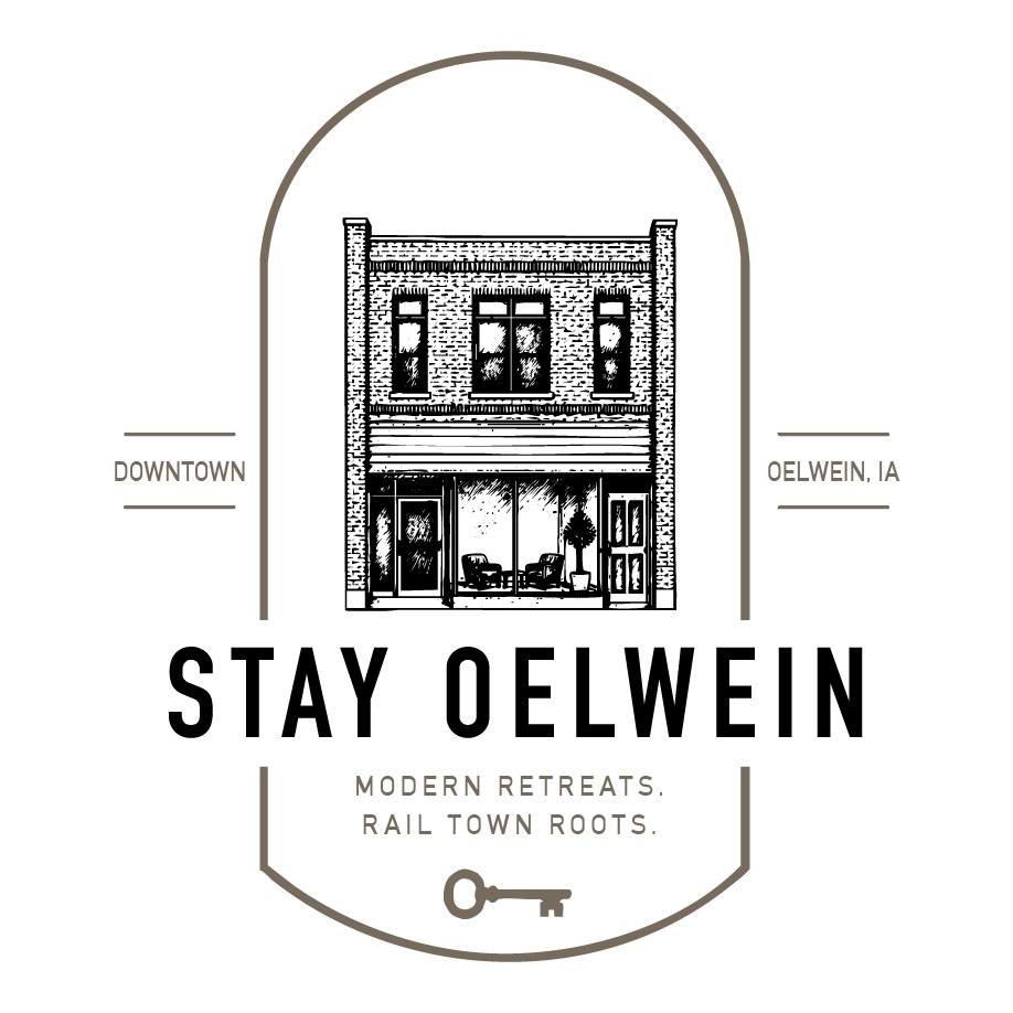 Stay Oelwein logo with historic storefront, “Downtown” and “Oelwein, IA,” plus key and “Modern retreats, rail roots.”