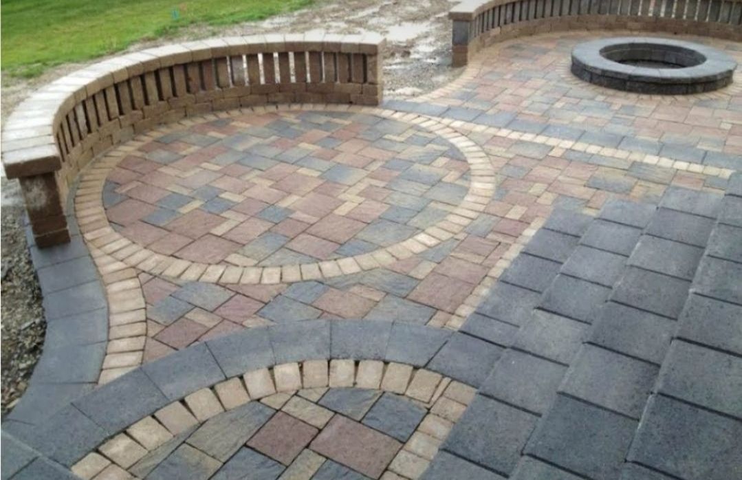 Brick patio with curved retaining wall and fire pit.