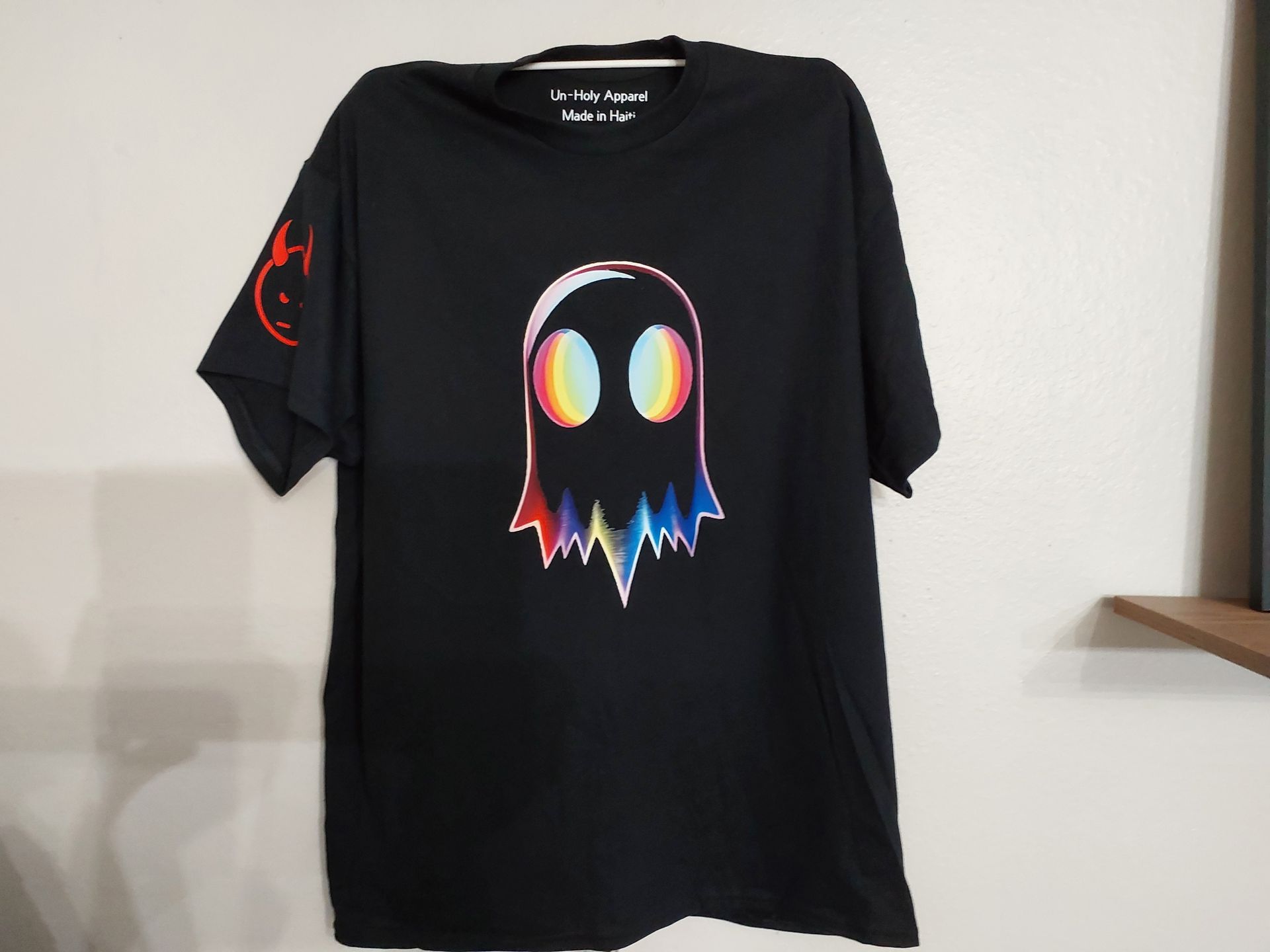 Black T-shirt with a colorful ghost graphic.