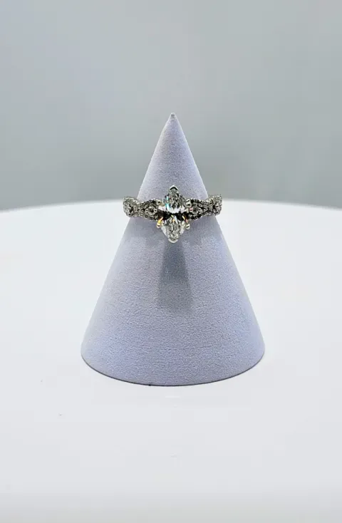 Diamond ring on a lavender display cone against a white background