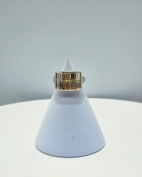 Gold ring on a light blue cone-shaped display stand against a gray background