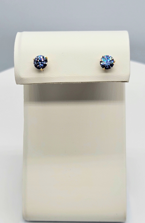 Pair of blue stud earrings on a cream display stand
