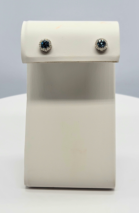 White leather jewelry box with a small flap lid and two sparkling stud earrings displayed on top
