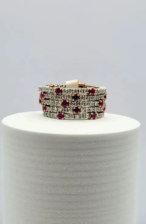 Ruby and clear gem bracelet on a white display stand