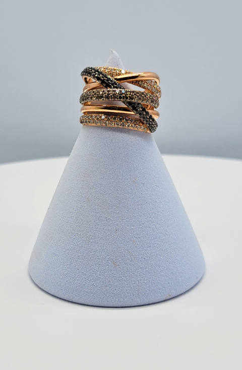 Light blue ring holder with stacked rose gold and black gemstone rings on top
