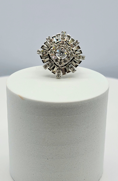 Diamond ring on a white display pedestal against a light gray background