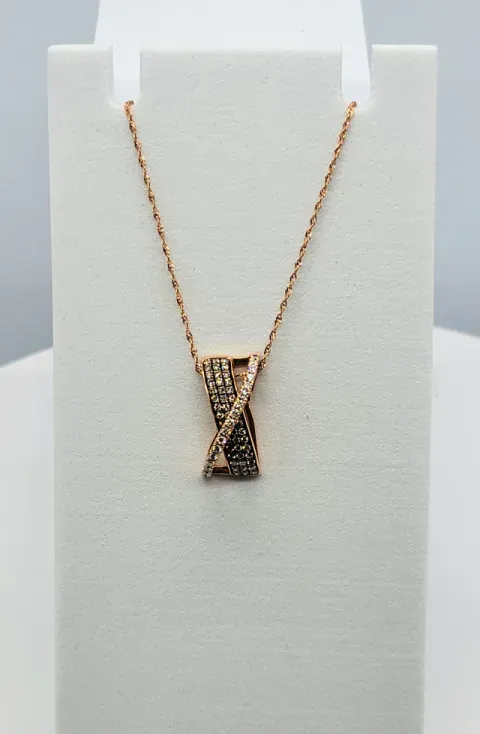 Rose gold pendant necklace with a rectangular textured charm on a white display bust