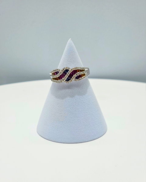 Gold and purple gemstone ring displayed on a white cone stand against a light gray background