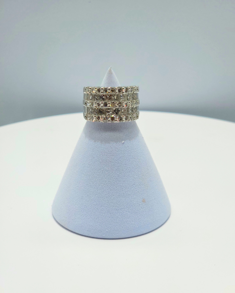 Silver ring with rows of small stones displayed on a light blue cone stand against a white background