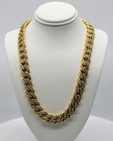 Gold woven chain necklace displayed on a white bust stand