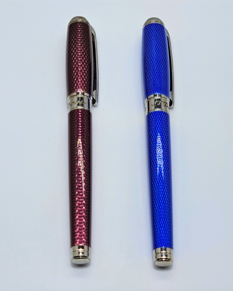 Two diamond-pattern pens, one burgundy and one blue, standing upright on a white background