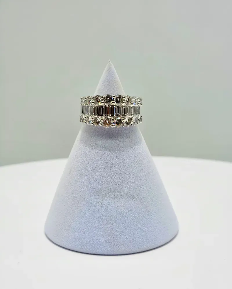 Diamond rings stacked on a white cone display against a light background