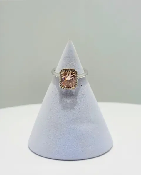 Conical lavender ring display stand with a square-cut gemstone ring on top