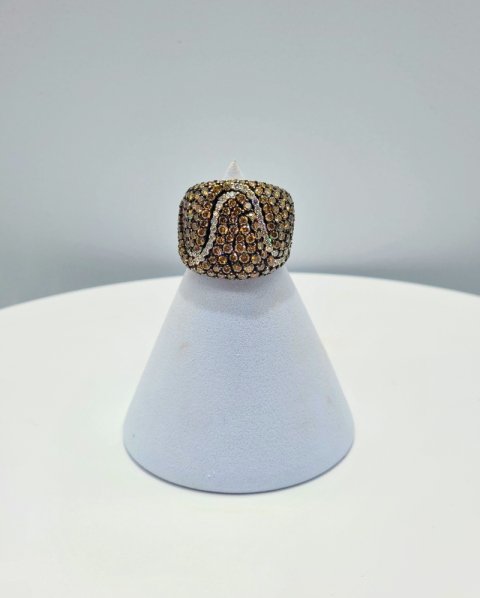 Brown jeweled ring on a white display cone against a light gray background