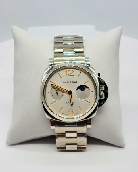 Silver Panerai wristwatch with white dial on a white display pillow