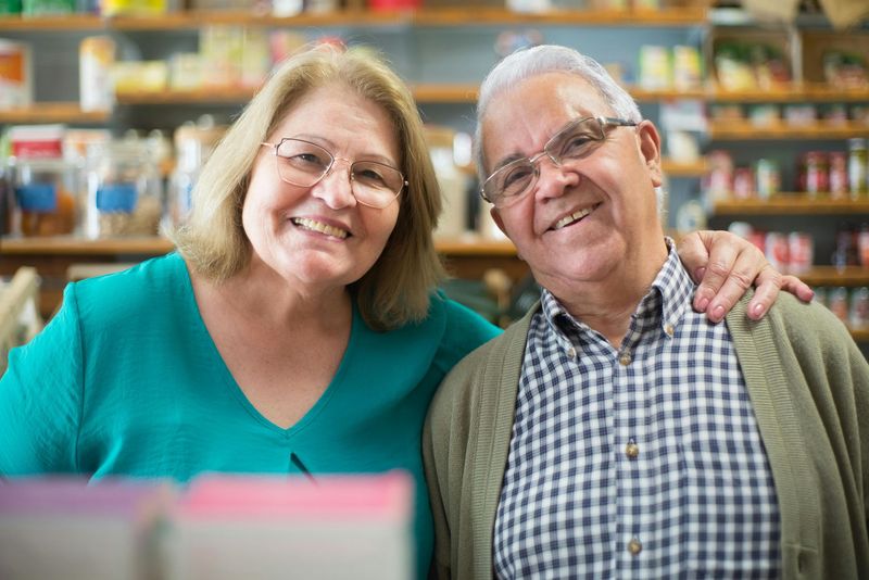 Two smiling people standing together in a grocery store aisle