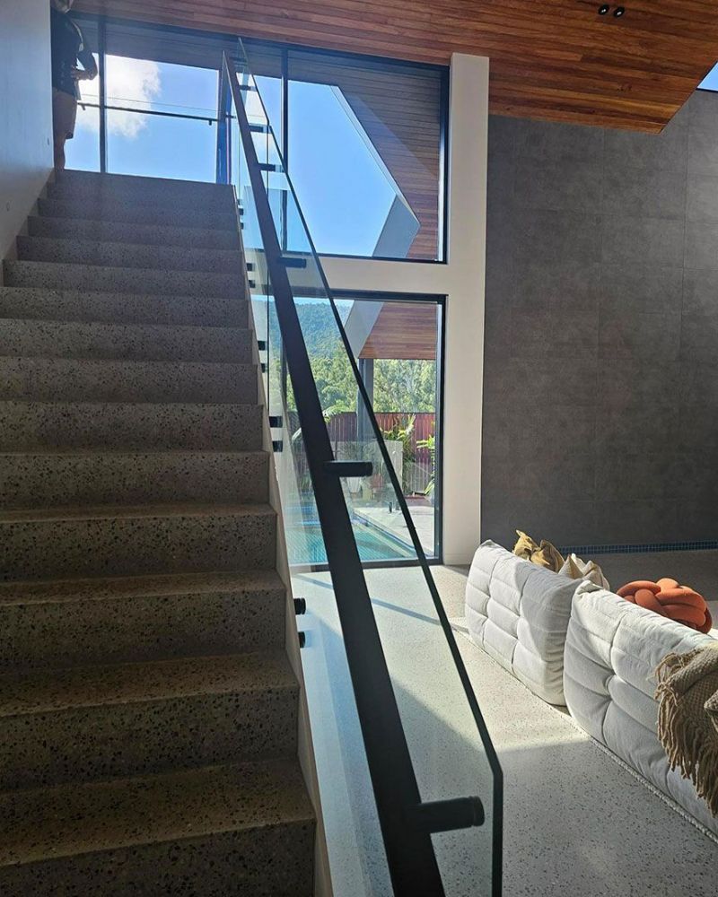 A Living Room with Stairs Leading up To the Second Floor — North Queensland Glass & Glazing In Cannonvale, QLD