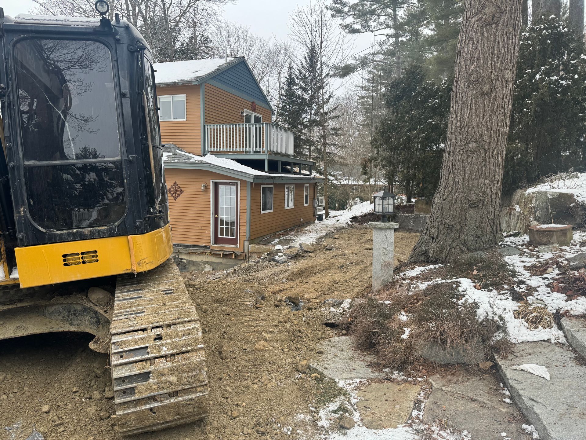 an excavator in a yard in winter