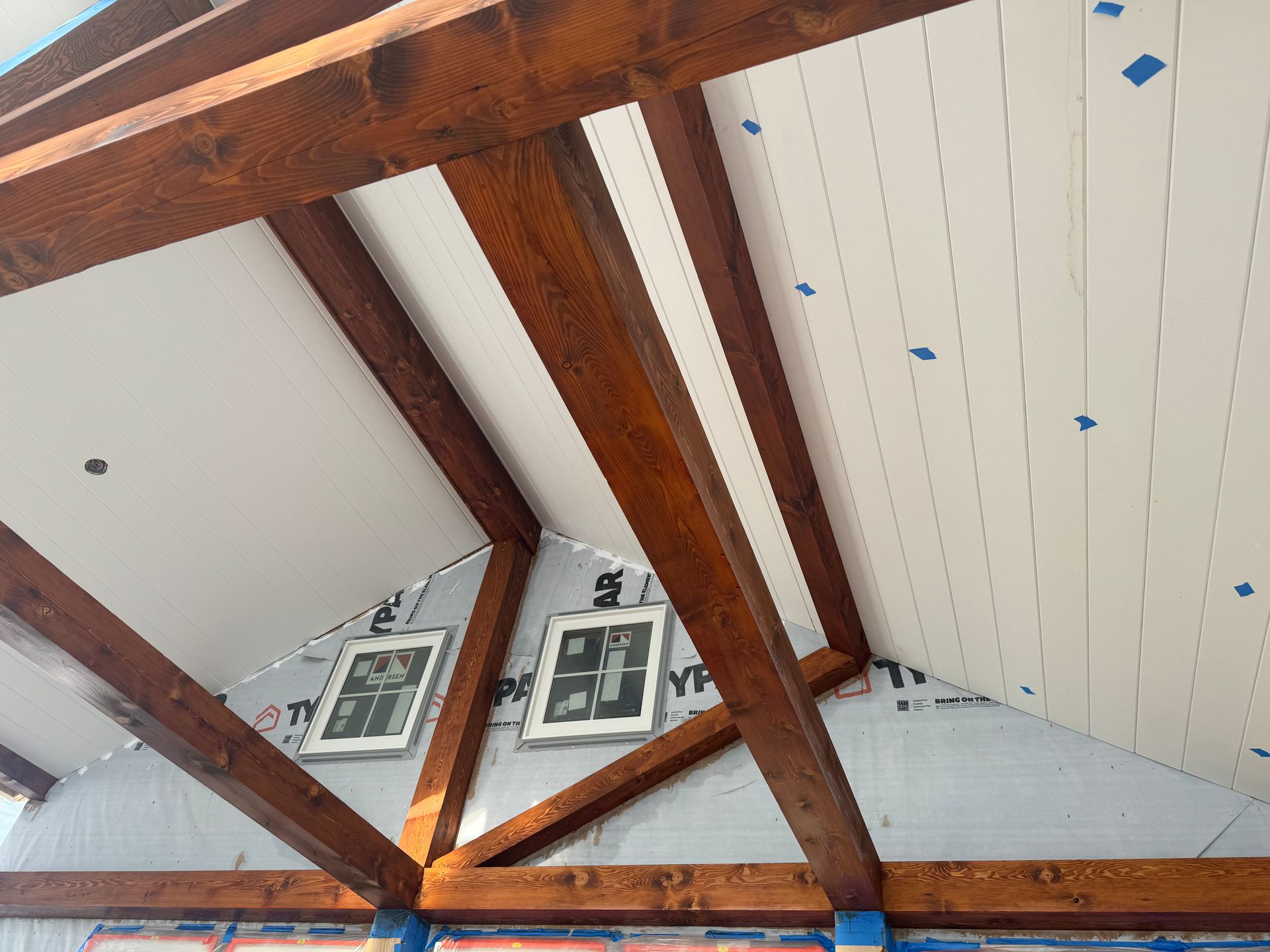 the inside of a room with exposed stained timber beams