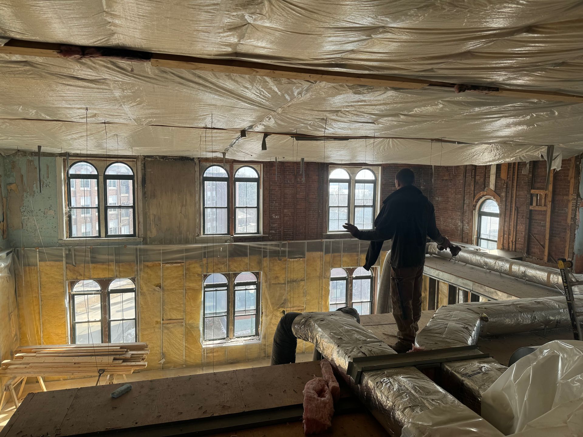 a historic building interior with arched windows being remodeled