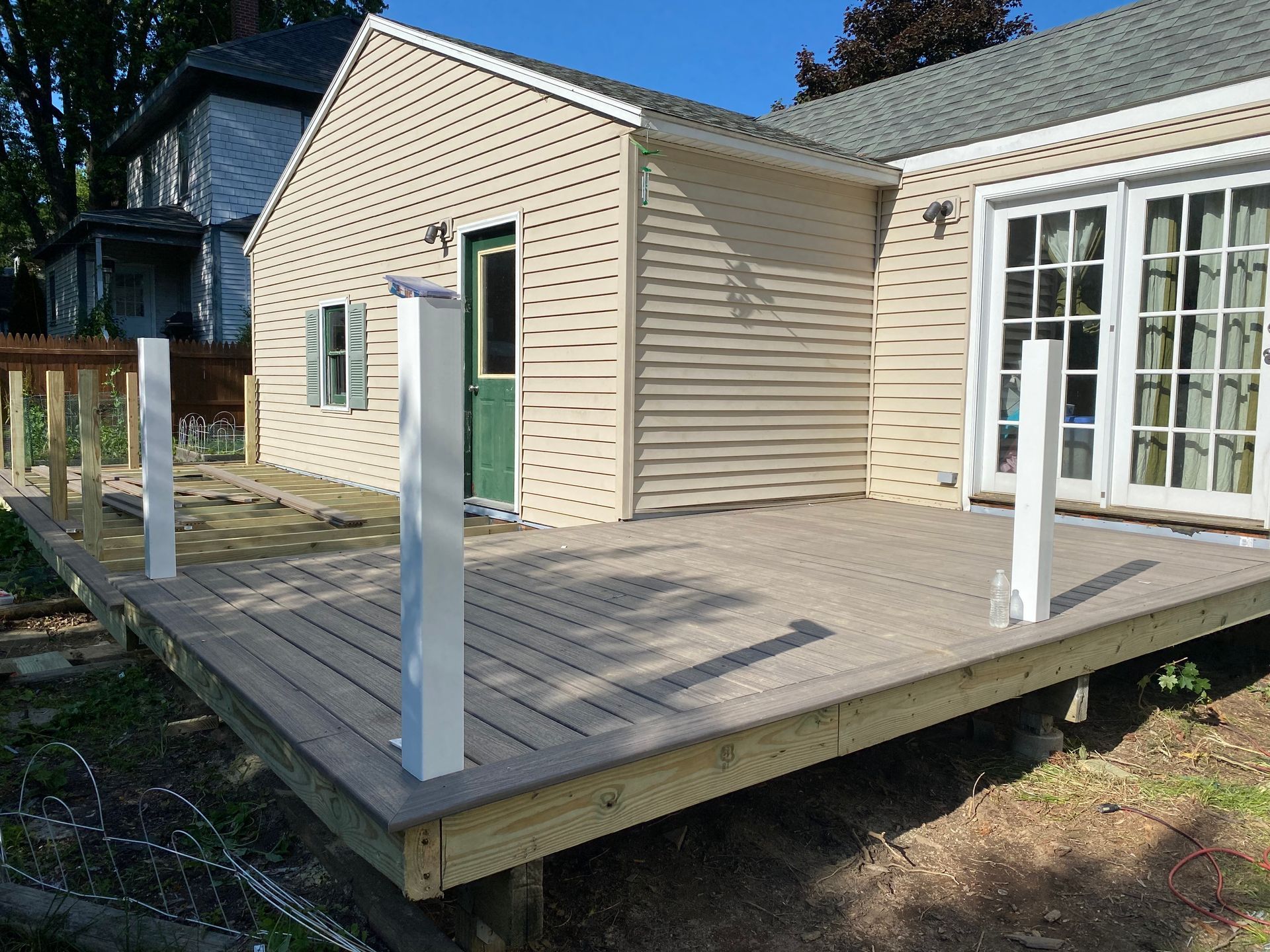 A small house with a wooden deck in front of it