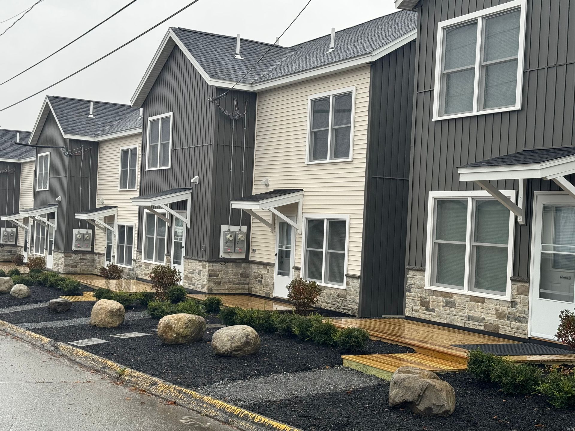a row of multi family houses with contrasting siding