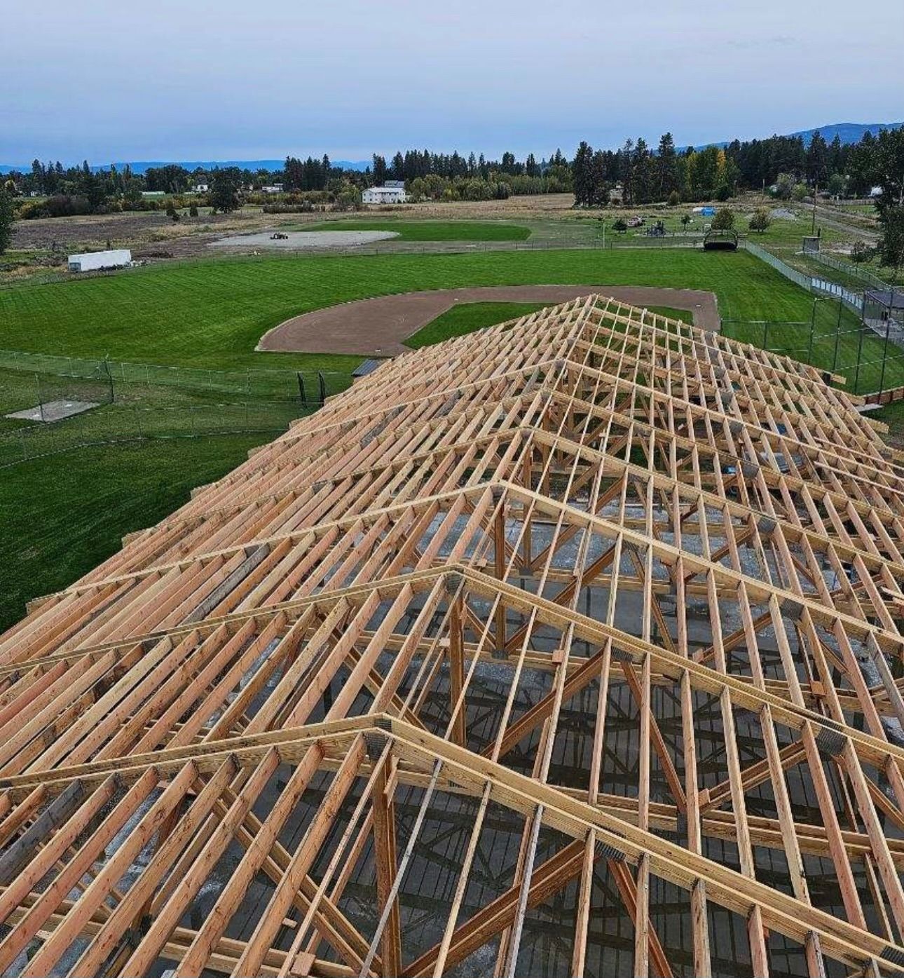 An aerial view of a large wooden structure under construction.
