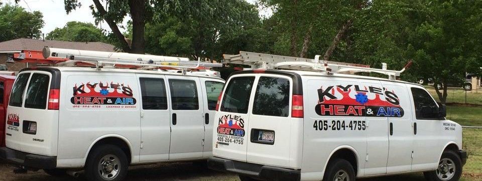 Two white vans with the logo 