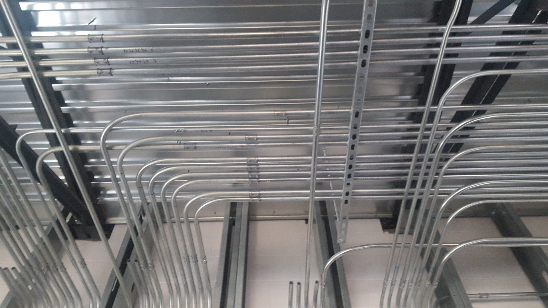 Electrical conduit pipes running across a ceiling.