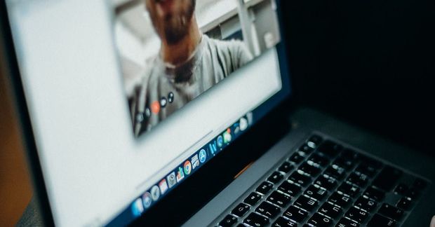 A laptop with a picture of a man on the screen