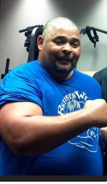 A man wearing a blue shirt that says british wrestler