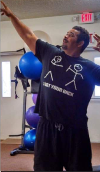 A man is wearing a shirt that says