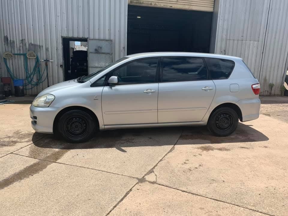A Silver Car Is Parked In A Parking Lot In Front Of A Building — J & T Mobile Mechanics In Highworth, QLD