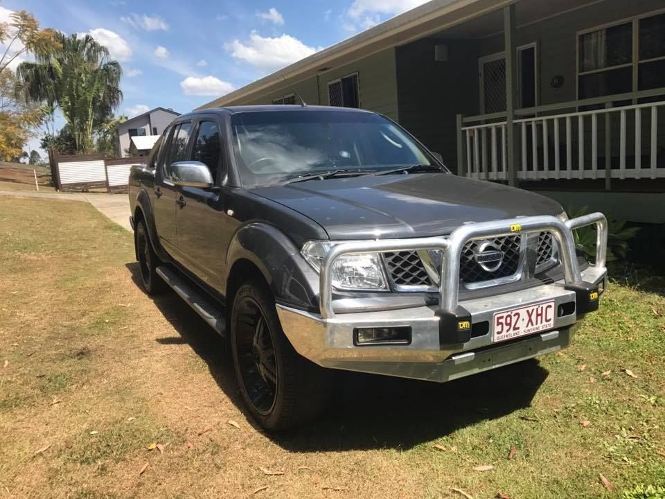 A Nissan Pickup Truck Is Parked In Front Of A House — J & T Mobile Mechanics In Highworth, QLD