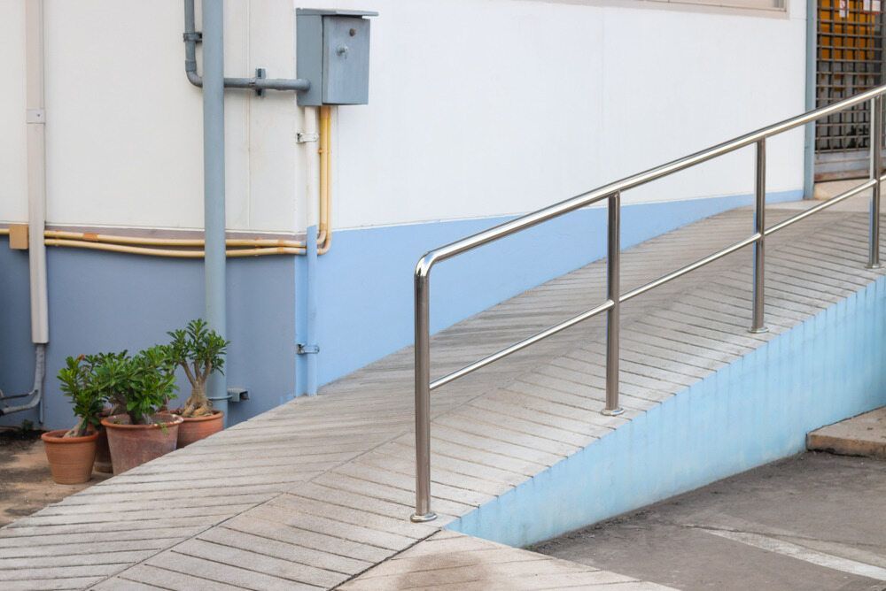 A Ramp With a Stainless Steel Railing is Leading to a Building — A1 Maintenance and Building In Nabiac, NSW