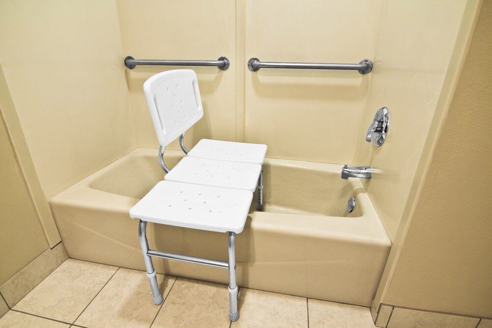 A Bathtub With a Chair Attached to It in a Bathroom — A1 Maintenance and Building In Wingham, NSW