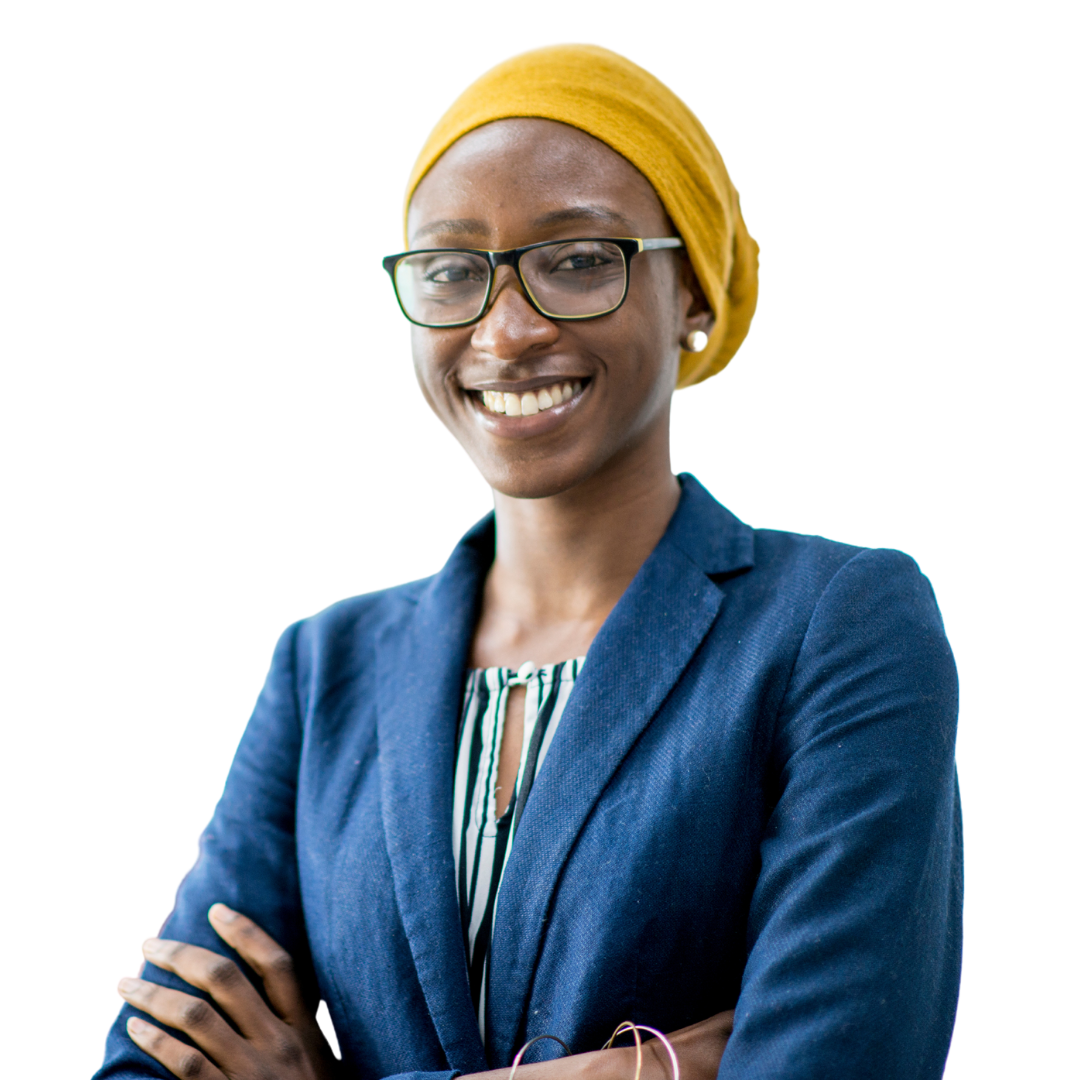 A woman wearing glasses and a turban is smiling with her arms crossed