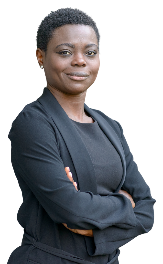 A woman in a black suit is standing with her arms crossed.