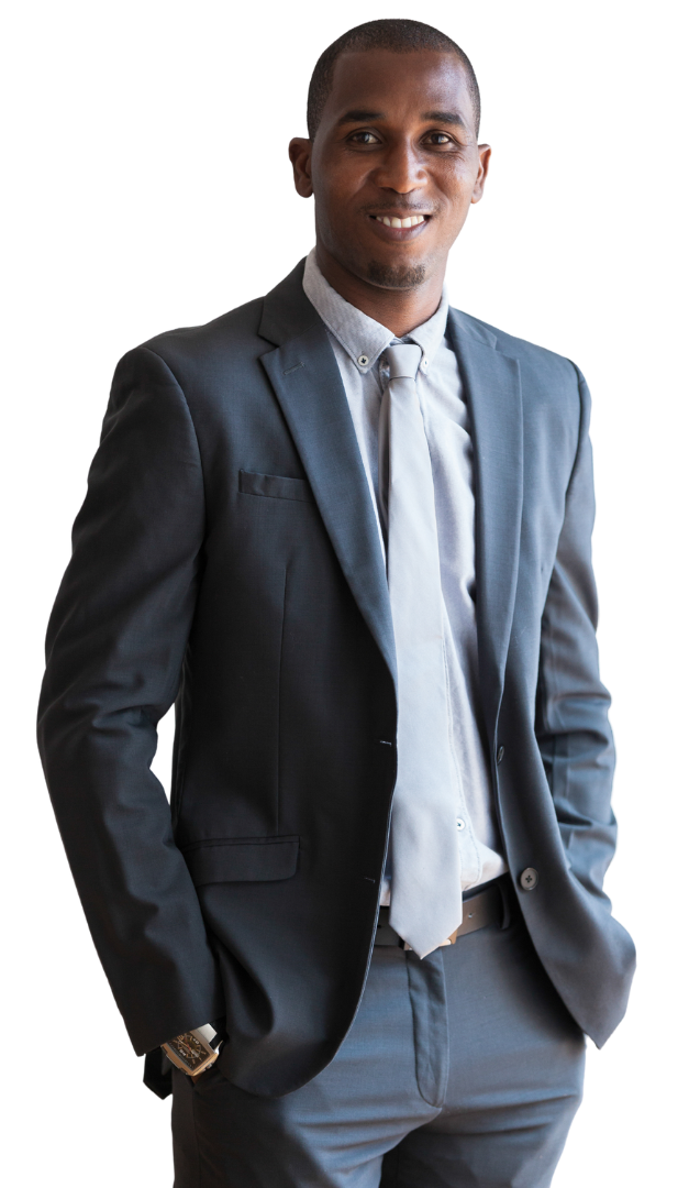 A man in a suit and tie is standing with his hands in his pockets.