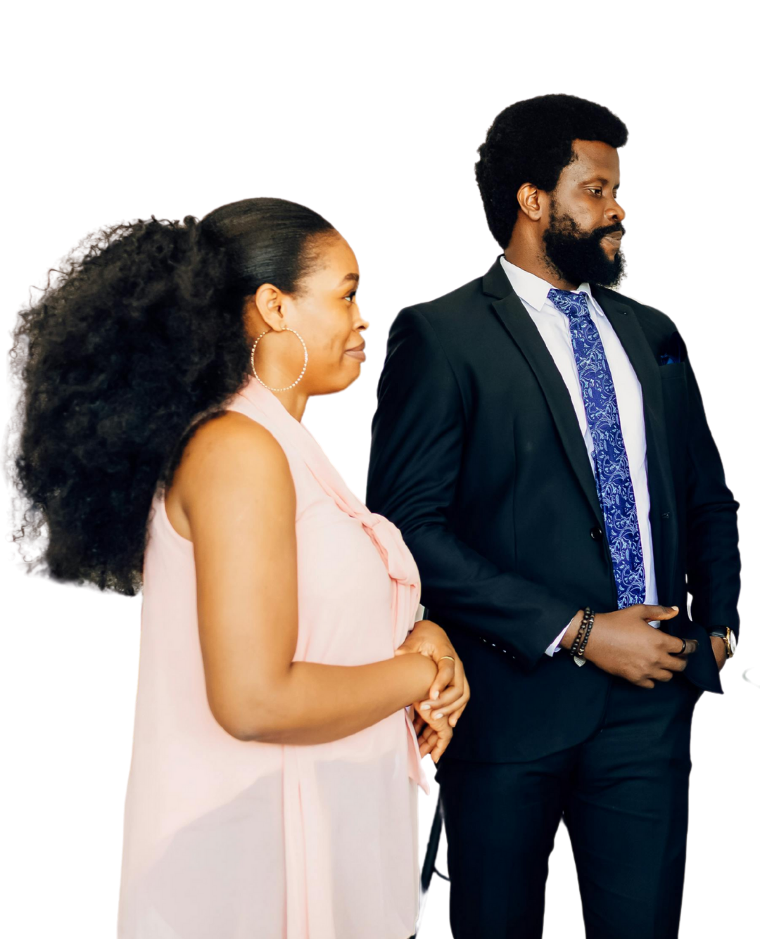 Woman with ponytail and man in suit looking away from each other.