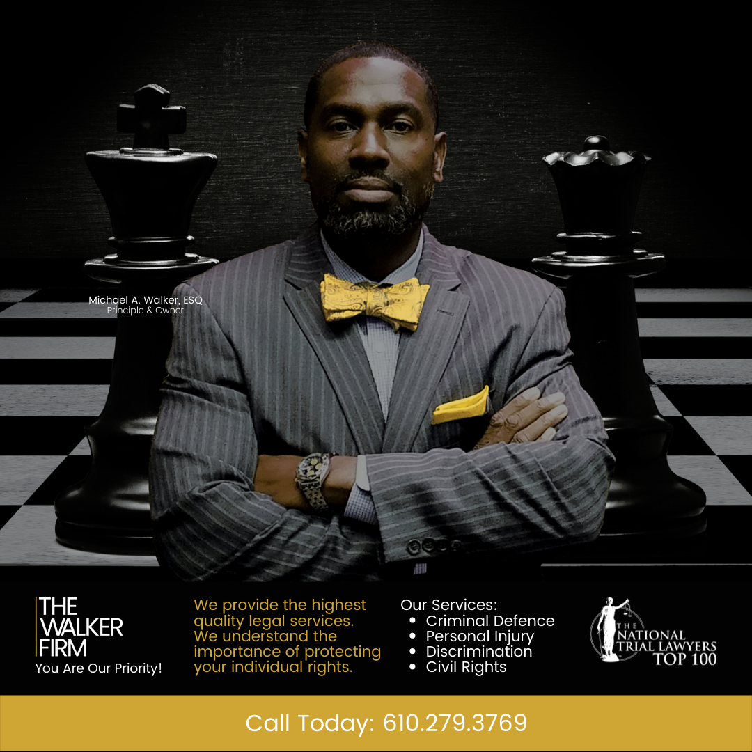 A man in a suit and bow tie is standing in front of a chess board.