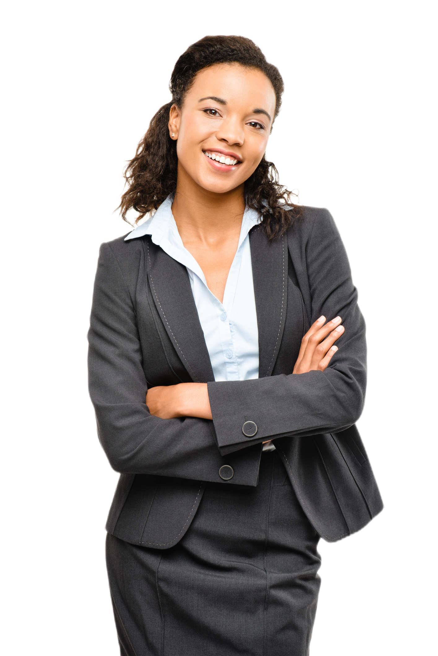 A woman in a business suit is standing with her arms crossed and smiling.