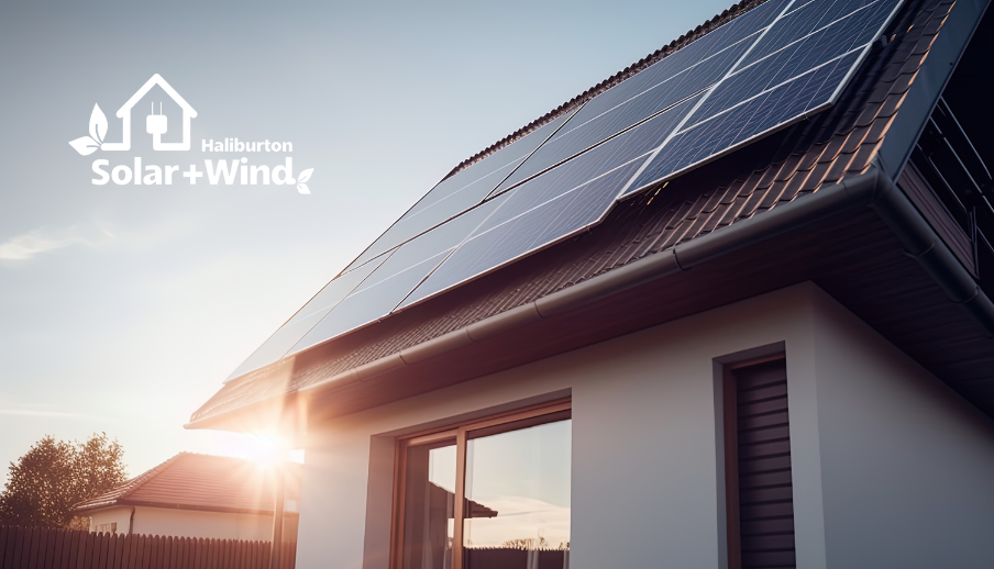 The sun is shining through the windows of a house with solar panels on the roof.