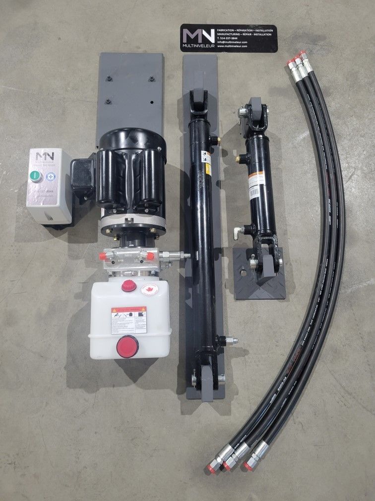 A hydraulic system is sitting on a concrete floor.