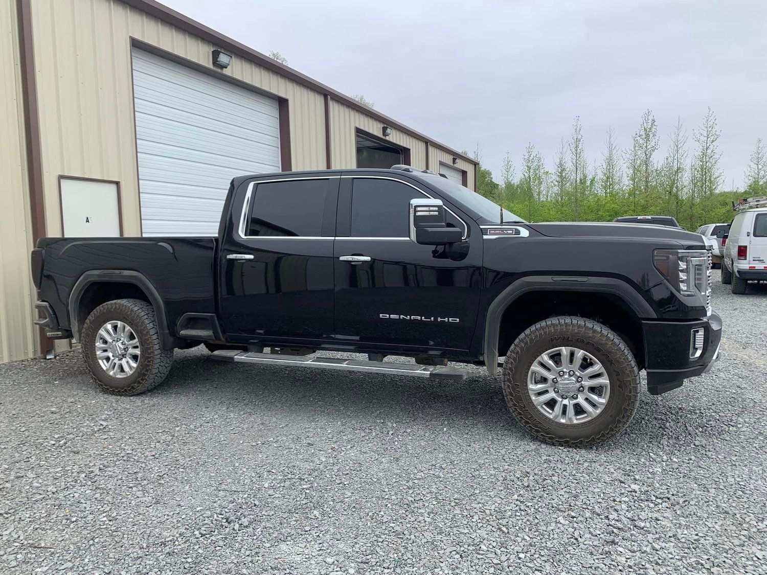 Black GMC Sierra truck parked outside a building.