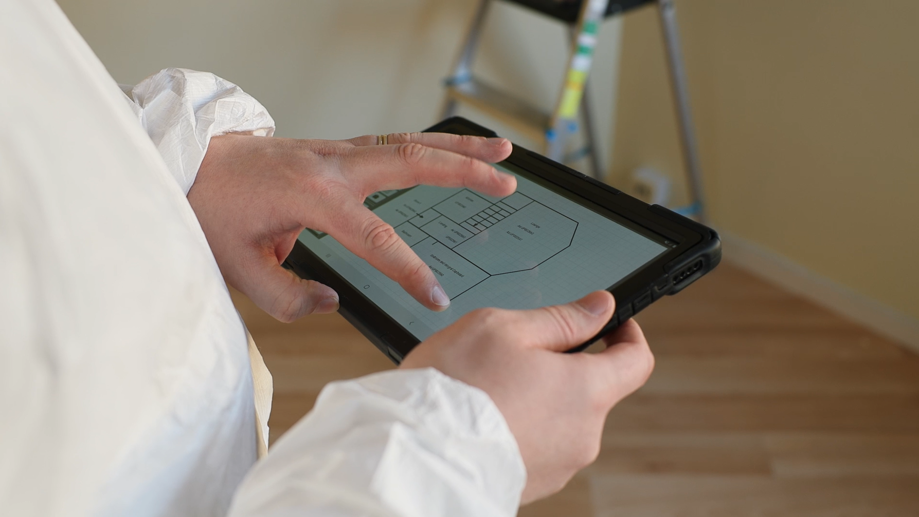 A person is using a tablet computer in a room.