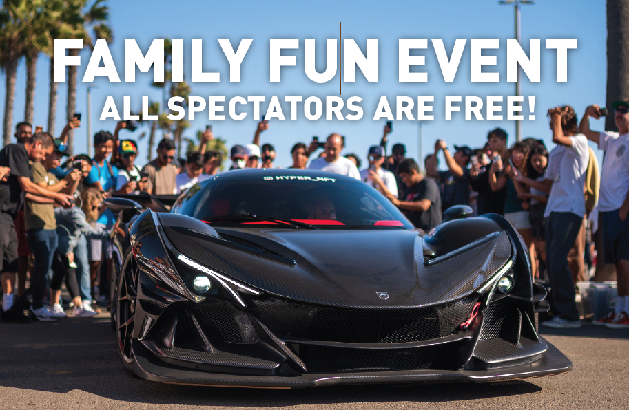 Cars N Copters on the Coast A black sports car on display at a family fun event with a large crowd; spectators are free.