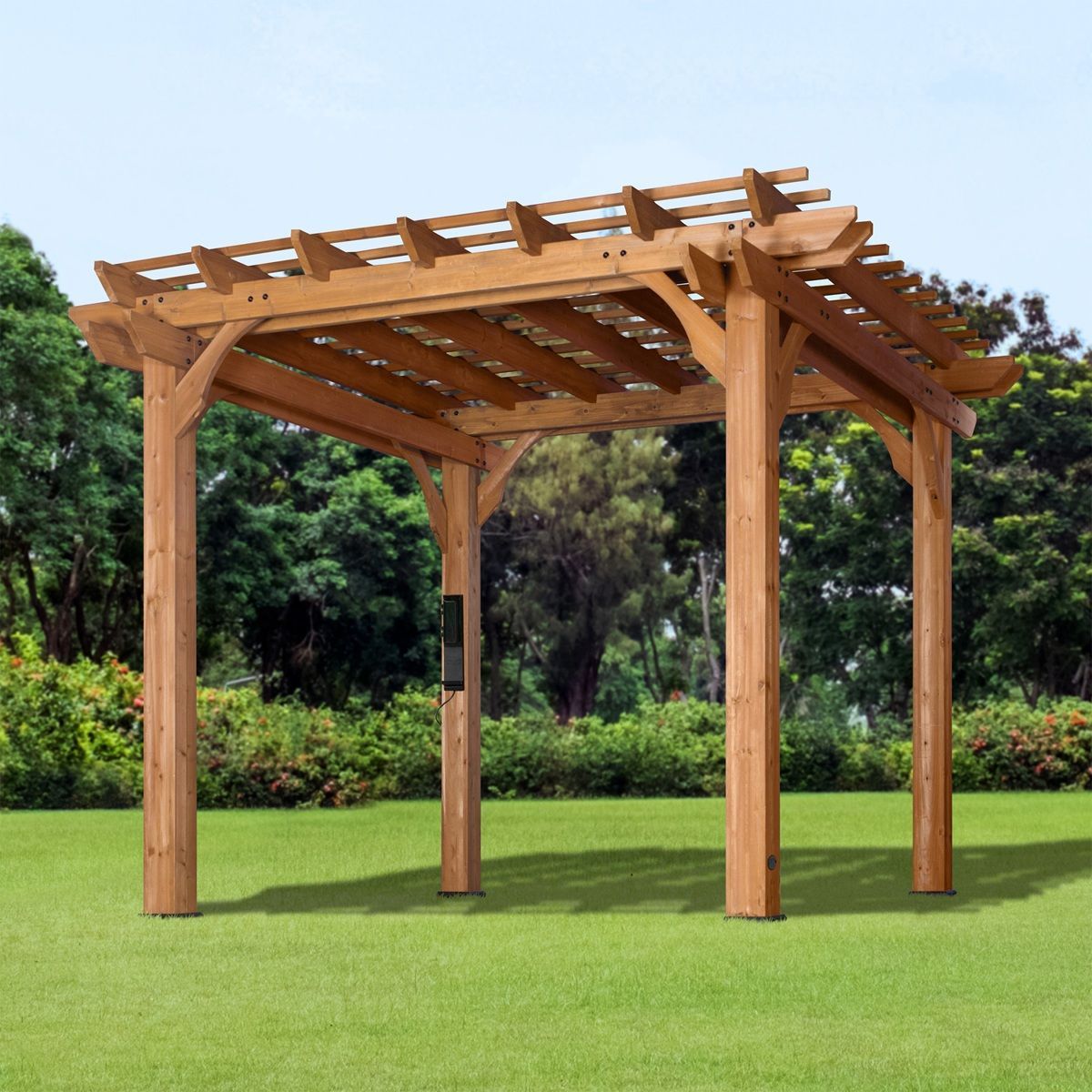 Wooden pergola on a green lawn in a park, with trees in the background.